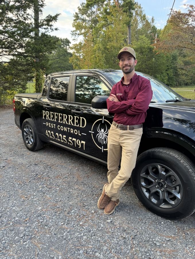 Jacob Richardson, owner of Preferred Pest Control, standing beside his company truck