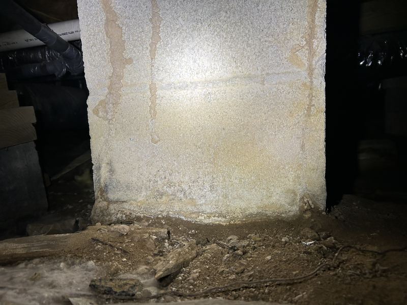 Termite tubes on a concrete block pier in a crawl space